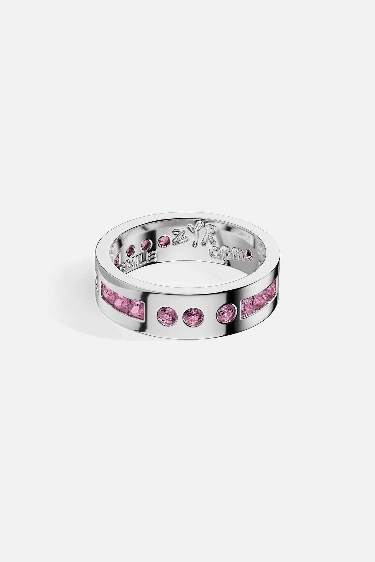 Silver ring with pink gemstones on a white background